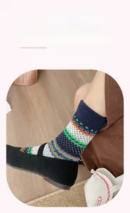 Detailed knit texture of colorful Fair Isle socks with widened elastic ribbed cuffs