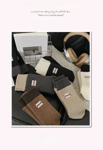 Detail of ribbed knit socks with embroidered label and warm thick cashmere-like texture