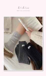 Detail of wool cable knit socks featuring egg label and warm thick texture for winter