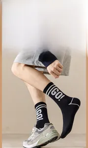 Detailed shot of black cotton sport socks featuring white stripes and GO! letter knit