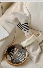 Detail of winter thermal wool socks with dog embroidery and thick sherpa lining