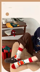 Close-up of cotton Christmas socks with Santa and reindeer motifs in a cozy setting