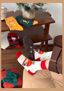 Close-up of festive Christmas crew socks with reindeer and gingerbread man holiday patterns
