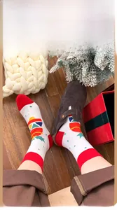 Cozy Christmas themed mid-calf socks with geometric knits worn with a brown clog shoe