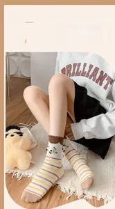 Detail of funny big eyes expression socks with brown stripes and cozy cotton texture