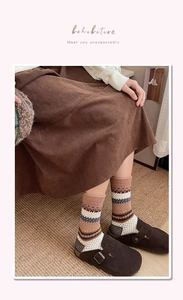 Close-up of Fair Isle crew socks with vintage jacquard patterns and warm khaki tones