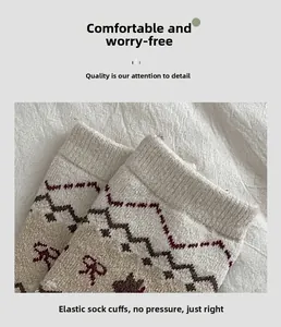 Detail of high-elasticity ribbed cuff on Fair Isle knit wool socks with bow accent