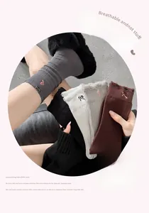 Detailed embroidery bow and distressed hole design on premium cotton mid-tube socks