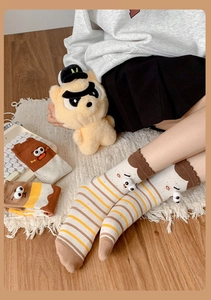 Close-up of funny cartoon eyes on mid-calf socks featuring creative brown stripe patterns