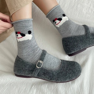Grey wool mid-calf socks with cartoon puppy pattern worn with plush Mary Jane shoes