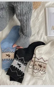 Close-up of Fair Isle thick wool socks with reindeer jacquard pattern in three colors