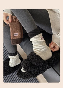 Detailed knit texture of thick winter crew socks with 'attends' patch and ribbed pattern