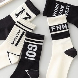 Athletic mid-calf cotton socks with letter prints and stripes in black and white colors