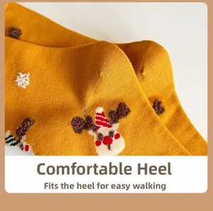 Detailed close-up of a festive yellow cotton sock heel with a cute deer embroidery