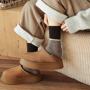 Brown suede platform mule slippers styled with warm striped wool socks and corduroy pants