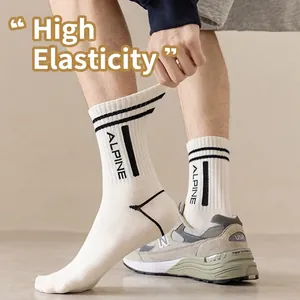 Stretchy white cotton mid-tube sports socks with ribbed cuffs and Alpine logo