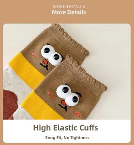 Detail of high-elastic ribbed cuff on khaki and yellow cartoon socks with plush eyes