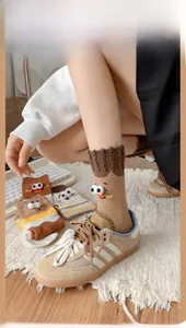 Detail of funny 3D big eyes on ribbed cotton crew socks in earthy brown and beige tones