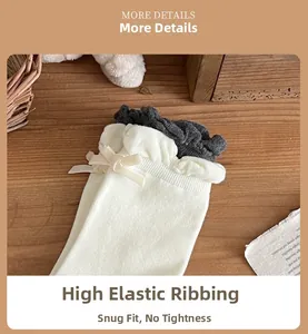 Detail of high-elastic knit socks with velvet bow and charcoal grey ruffle trim