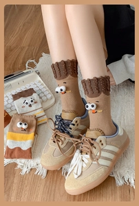 Detailed knit texture of earthy tone socks with 3D eyes and cute embroidery