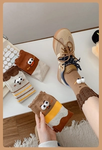 Detailed close-up of funny 3D big eyes crew socks with wavy elastic cuffs in earth tones