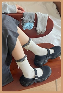 Detail of combed cotton mid-tube socks featuring cute bow knots and ruffled bubble cuffs