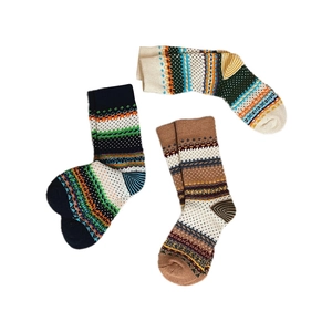Three pairs of vintage Fair Isle crew socks with ethnic patterns on white background