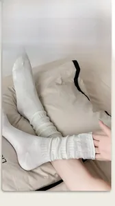 Close-up of cream-white ribbed calf socks with soft texture and natural slouchy style