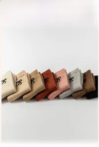 Detailed knit texture and bow embroidery on multi-color thick wool mid-calf socks