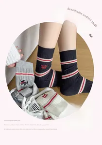 Detailed view of knitted cotton crew socks featuring cute puppy embroidery and stripe accents