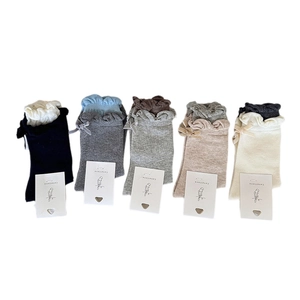 Set of 5 pairs of cotton mid-calf socks with floral ruffle trim and bow accents