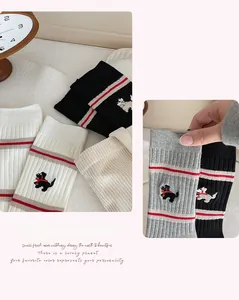 Detailed embroidery of puppies and stripe accents on these cotton blend crew socks