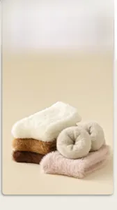 Close-up of thick plush mink velvet socks in assorted warm autumn colors and textures