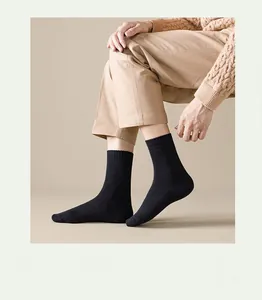 Detailed view of black cotton mid-tube socks featuring thick knit texture and soft comfort