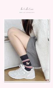 Close-up of navy crew socks with dog embroidery and sporty stripes for a cozy look