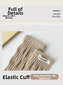 Close-up of khaki ribbed cotton socks featuring white Stayloose woven labels on elastic cuffs