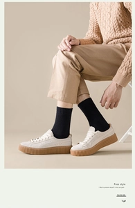 Detail of off-white suede low-top sneakers with thick brown gum platform sole for men