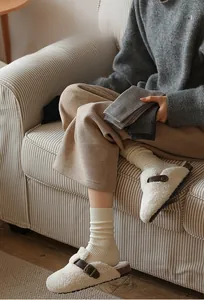 Detail of thick ribbed winter socks in beige and grey colors for casual warmth