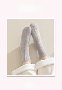 Close-up of grey plush socks featuring a comfortable cuff and high elastic texture