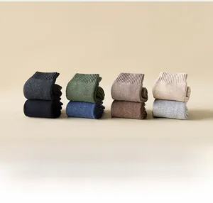 Detailed stack of thick cotton crew socks in eight warm neutral colors for autumn