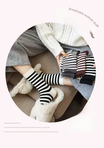 Close-up of soft cotton striped mid-tube socks with elastic ribbed cuffs for women
