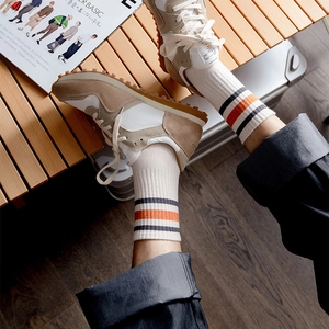 Men's casual mid-tube cotton socks with classic stripes paired with stylish sneakers