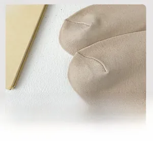 Detailed close-up of flat seamless toe stitching on beige cotton calf socks