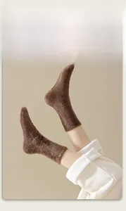 Close-up of thick brown faux mink fur thermal socks paired with cozy ribbed loungewear