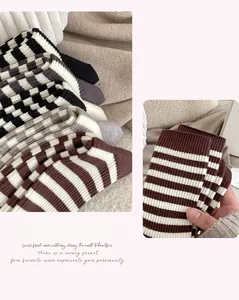 Close-up of thick striped winter socks with elastic ribbed cuffs and knit texture