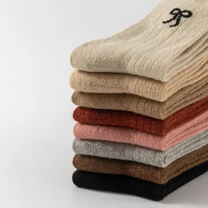 Thick wool knit socks for women in multi-color stack with elegant bow embroidery details