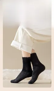 Detail of plush black mink fleece socks showing thick fuzzy texture and warm mid-calf fit