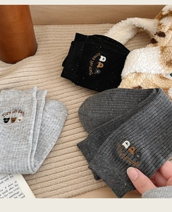 Detailed embroidery of three cartoon bears on colorful speckled cotton mid-calf socks