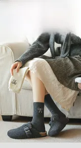 Detail of wool socks with bow embroidery and soft knit texture for winter warmth