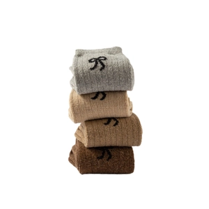Thick wool crew socks for women in earth tones with stylish black bow jacquard patterns